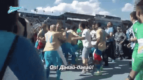 a crowd of people are dancing in front of a sign that says ' on '