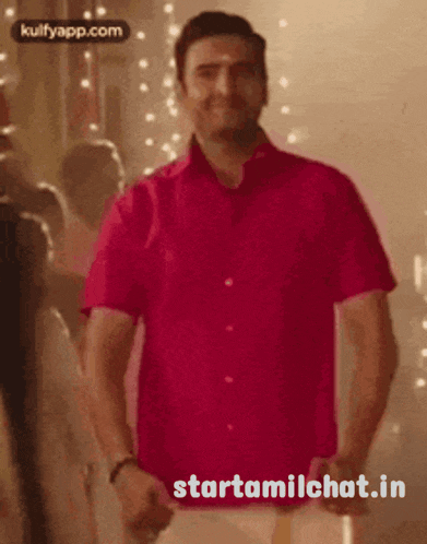 a man in a red shirt is dancing with the words starttamilchat.in written below him