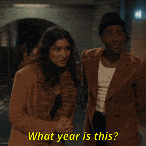 a man and a woman standing next to each other with the words what year is this written in yellow