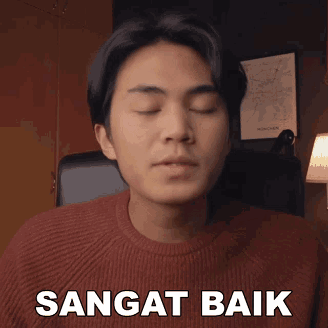 a man with his eyes closed has the word sangat baik written on his face