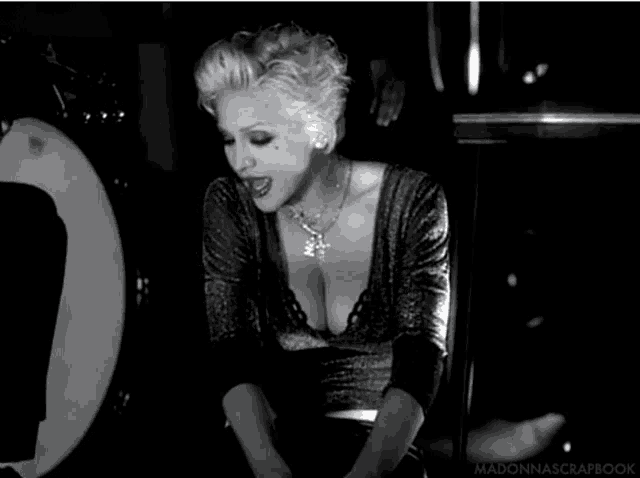 a black and white photo of a woman with the words madonnascrapbook on the bottom