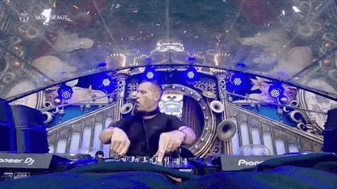 a man playing music on a pioneer dj mixer