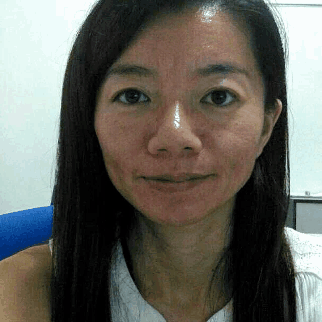 a close up of a woman 's face with a white shirt on