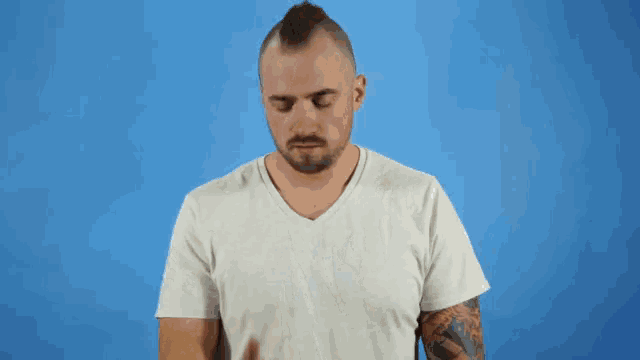 a man covering his face with his hand next to an emoji of poop