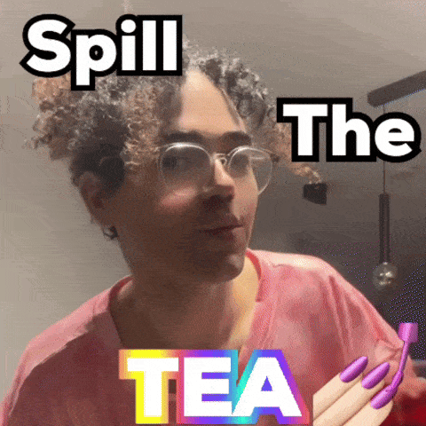 a man with glasses and purple nails has the words spill the tea on his face