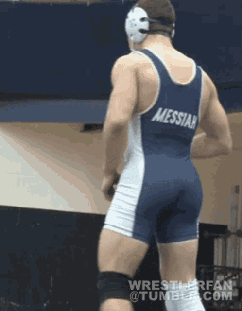 a wrestler with messiah on his back