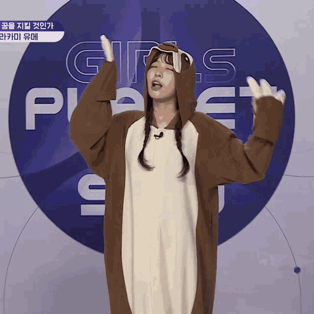 a girl in a squirrel costume stands in front of a girls planet logo