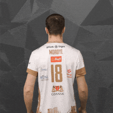 a man is wearing a white jersey with the number 18 on it