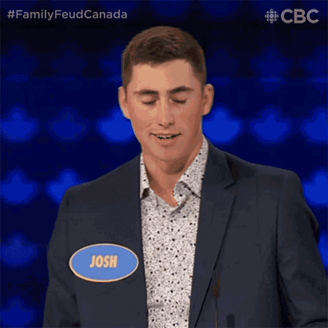 a man in a suit has a name tag on his jacket that says josh