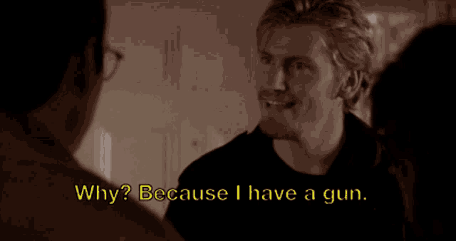 a man talking to another man with the words why because i have a gun behind him