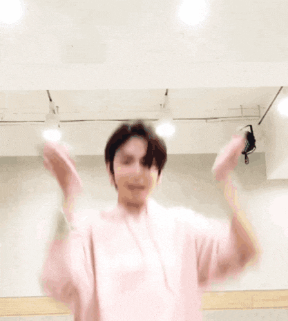 a young man wearing a pink hoodie that says gentle on it
