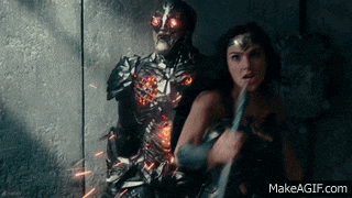 a woman holding a sword is standing next to a man in armor with red eyes