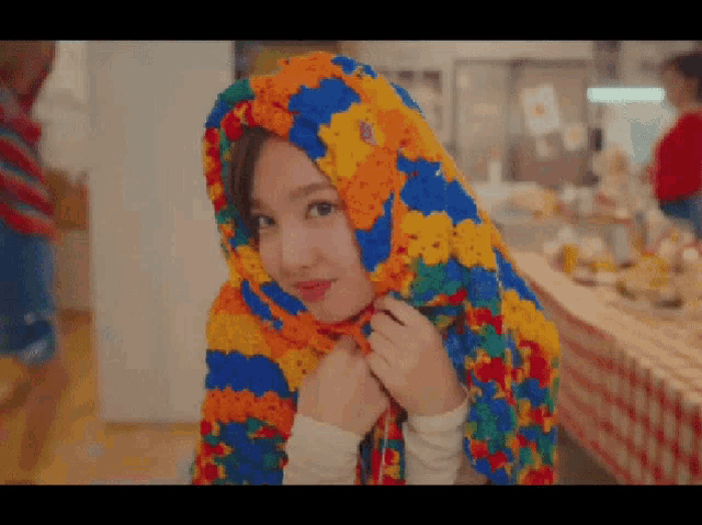 a woman with a colorful scarf around her head