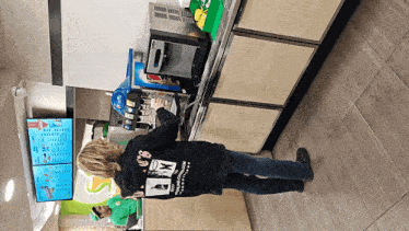 a woman wearing a black hoodie that says ' i love you ' on it