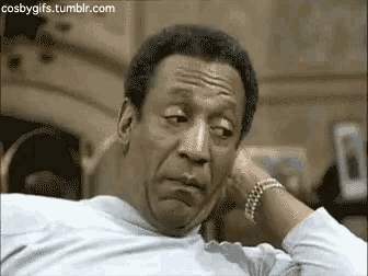 a man is sitting in a chair with his hand on his chin and making a funny face .
