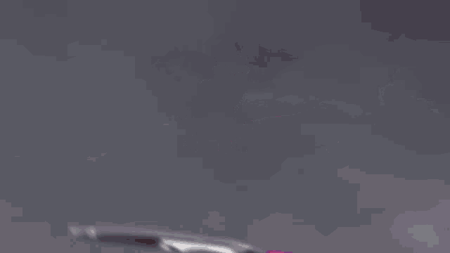 a red and purple robot is flying through the air