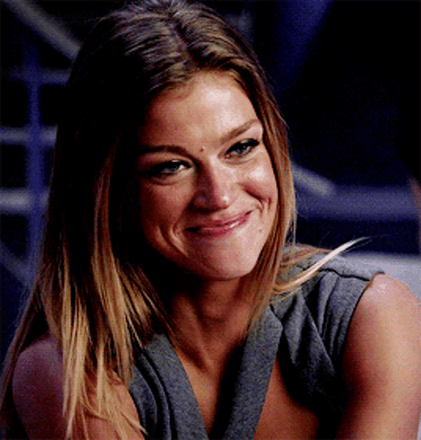 a close up of a woman 's face smiling