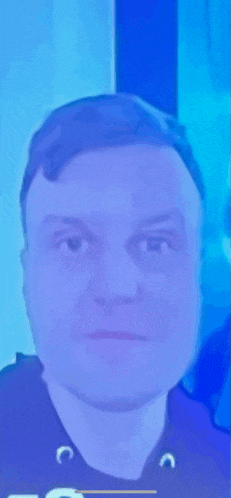 a close up of a man 's face against a blue background .