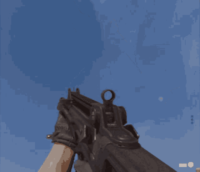 a close up of a gun with a blue sky background