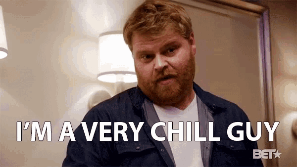 a man with a beard is saying `` i 'm a very chill guy '' while standing in a room .