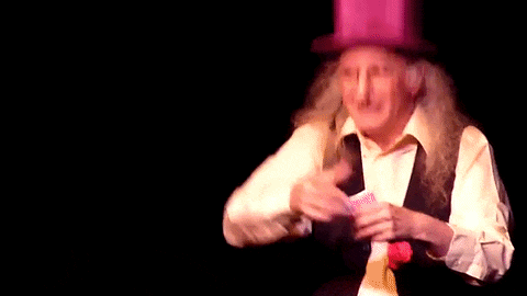 a man with long hair is wearing a purple top hat