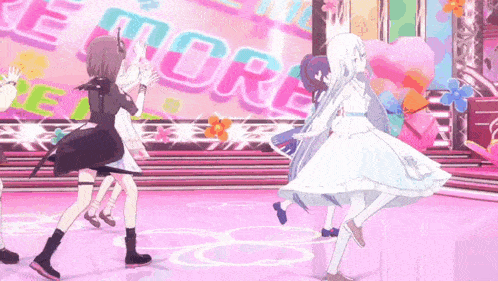 a group of anime girls are dancing on a stage with the word more in the background