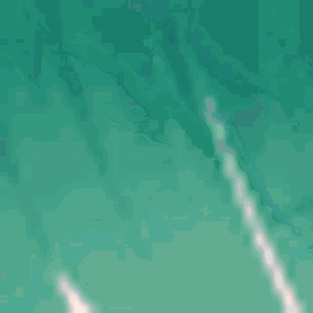 a close up of a person 's face with a green haircut .