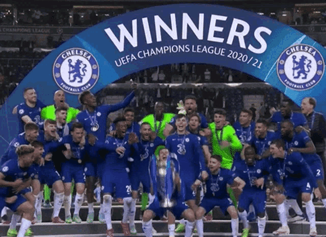 a group of soccer players are standing under a banner that says winners