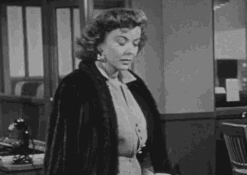 a woman in a fur coat smoking a cigarette
