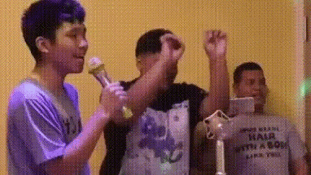 a man wearing a shirt that says ' hair with a bow ' on it