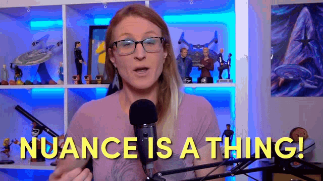 a woman speaking into a microphone with the words nuance is a thing written below her