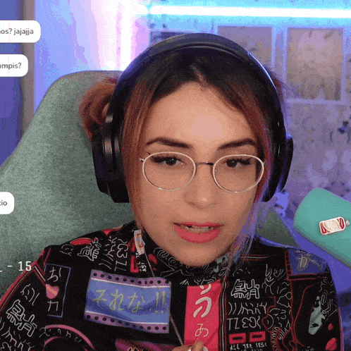 a woman wearing glasses and headphones has a sticker that says all the feels