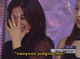 a woman covering her face with her hand and the words naeyeon judging her behind her