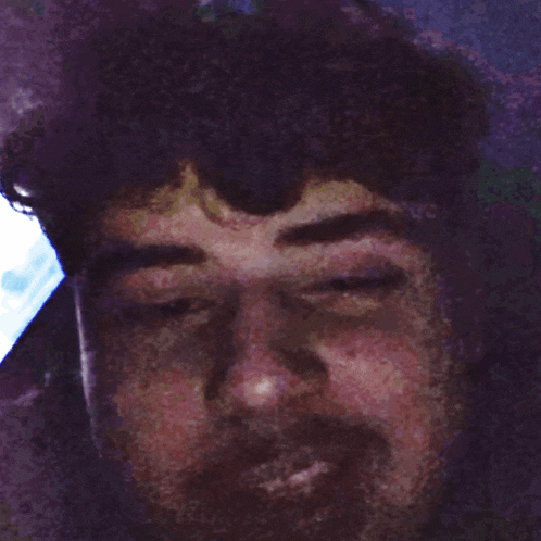 a close up of a man 's face with a blurry background