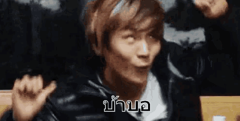 a man in a leather jacket is making a funny face and making a funny face .