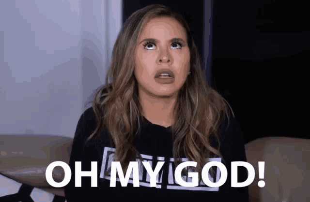 a woman wearing a black shirt with the words oh my god on it