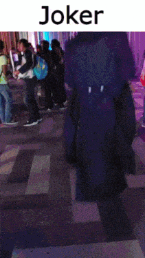 a group of people standing on a tiled floor with the word joker on top
