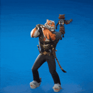a man dressed as a tiger is holding a cat on his shoulders