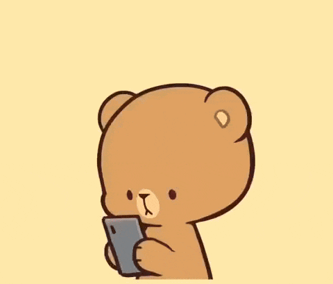 a cartoon character with pink hair is holding a cell phone in his hand .