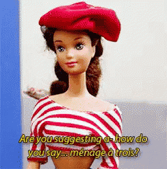 a barbie doll is wearing a red hat and a striped shirt