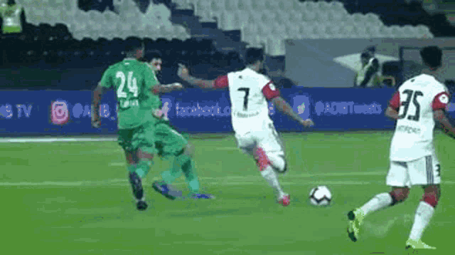 a group of soccer players are playing a game on a field