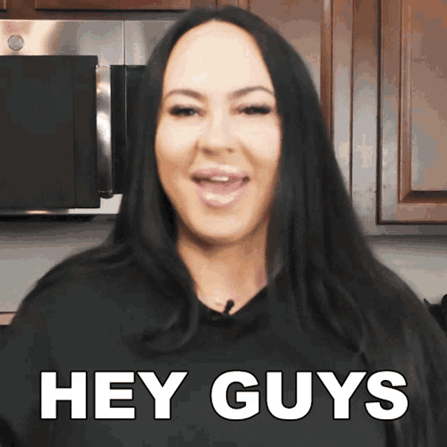 a woman says hey guys in a kitchen