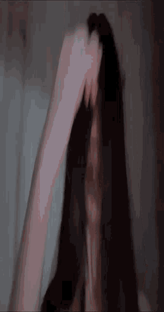 a close up of a person 's hand holding a black object .