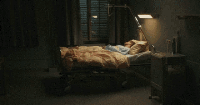 a man in a hospital gown is laying in bed