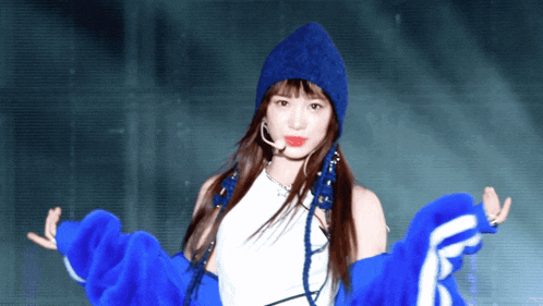 a woman wearing a blue hat and blue jacket