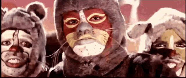 a group of people wearing animal masks are smiling for the camera