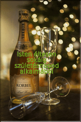 a bottle of korbel brut rose sits on a table next to two champagne glasses