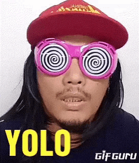 a man wearing hypnotic glasses and a hat with the word yolo on it