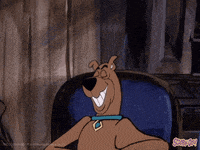scooby doo is sitting in a chair with his mouth open