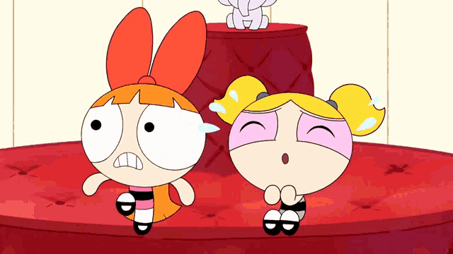bubbles and blossom from the powerpuff girls are sitting next to each other
